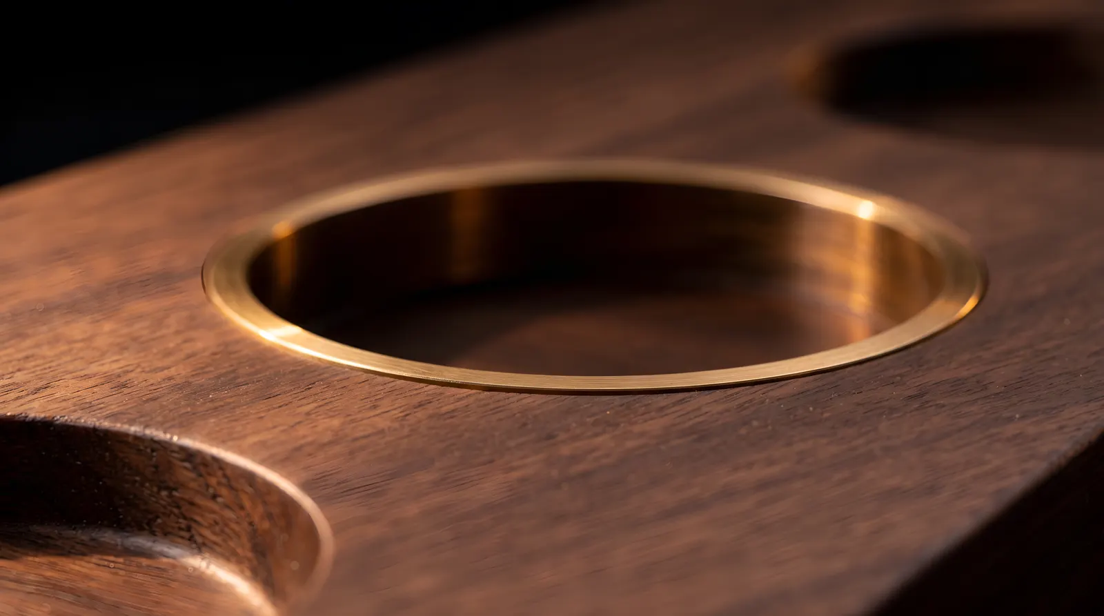 The brass ring, flush in the walnut