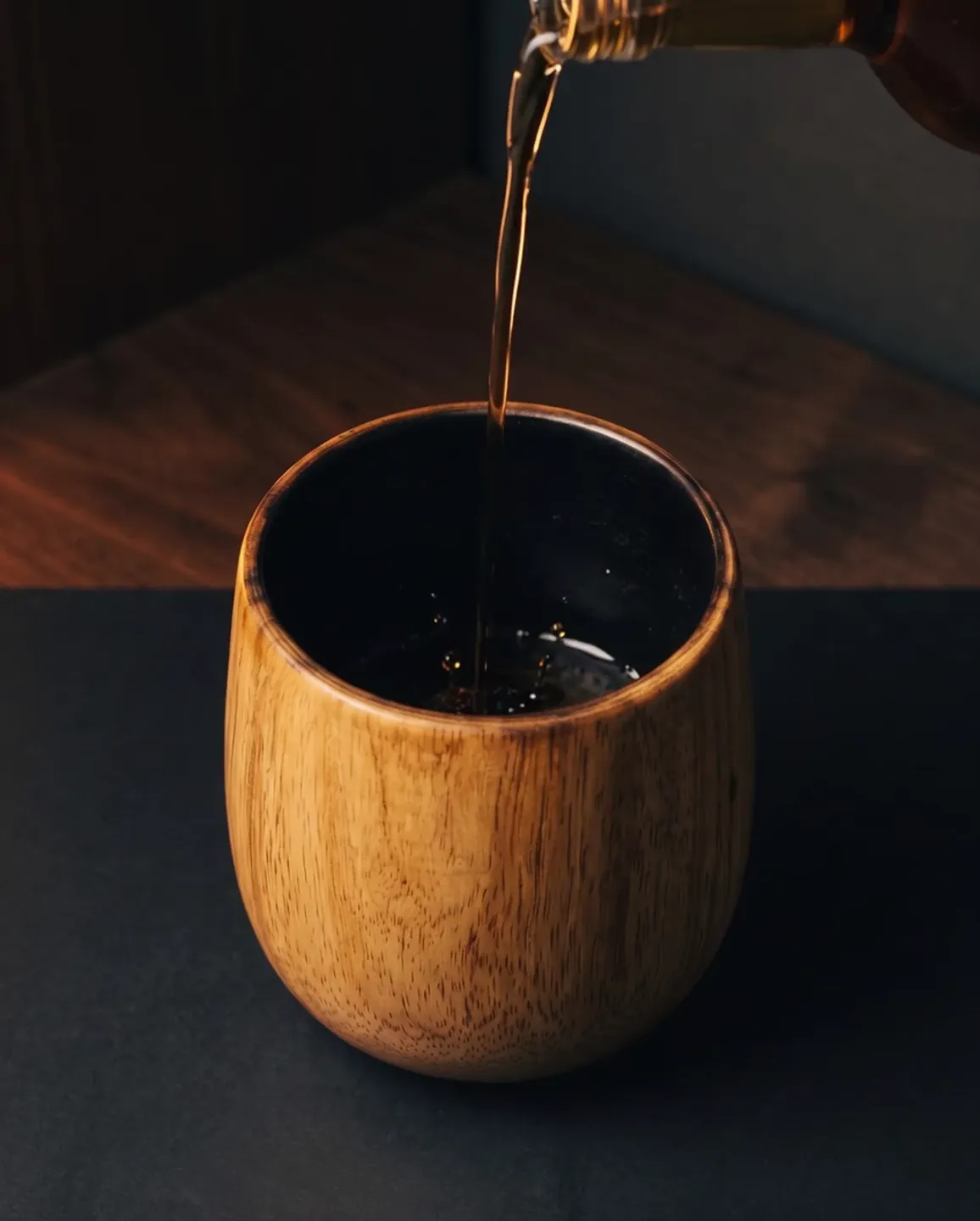Whiskey poured into the charred oak glass